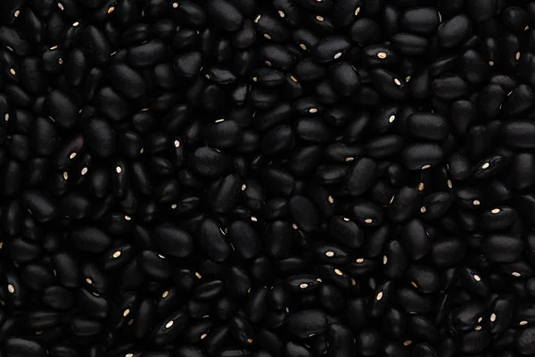 Svarta bönor närbild ovanifrån bakgrund. — Stockfoto