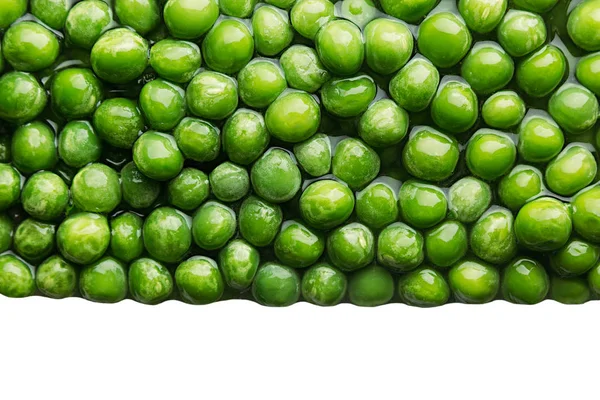 Border of wet fresh  green peas in water closeup on white background. — Stock Photo, Image