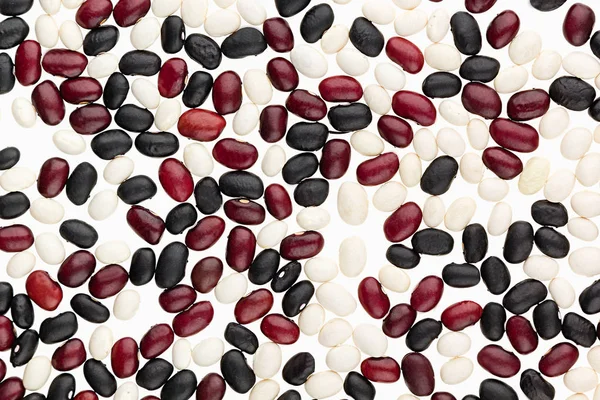 Mezcla de frijoles negros, rojos, blancos primer plano vista superior fondo . — Foto de Stock