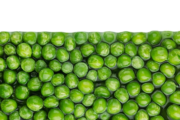 Border of wet fresh  green peas in water closeup on white background. — Stock Photo, Image