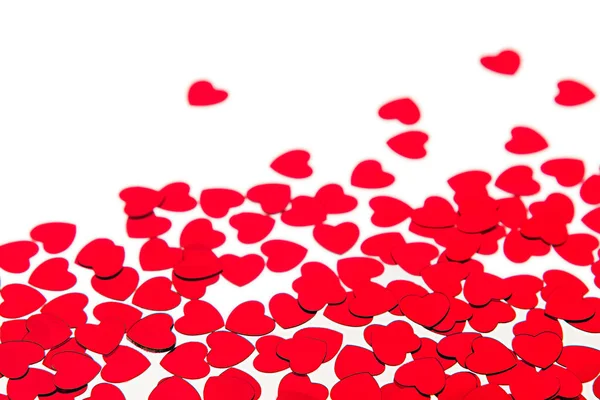 Valentijnsdag rand van rode harten confetti met kopie ruimte op witte achtergrond. — Stockfoto