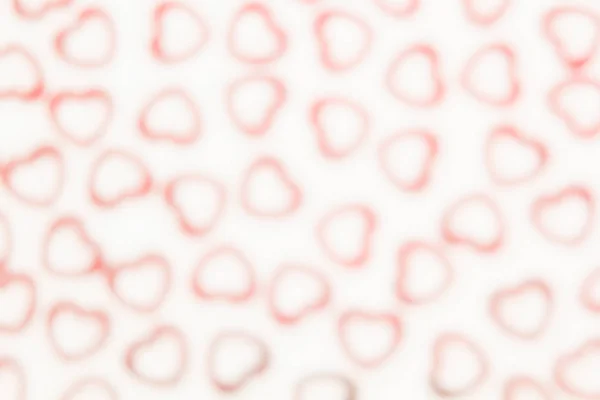 Valentin-nap dekoratív puha blur absztrakt mintás fehér alapon piros szív konfetti. — Stock Fotó