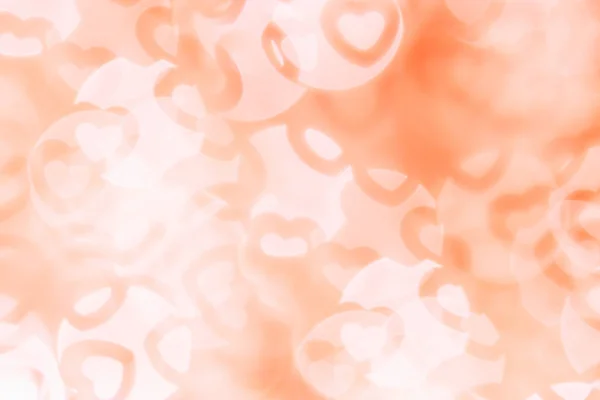 Valentine's day fond abstrait d'orange doux, blanc bokeh flou coeurs . — Photo