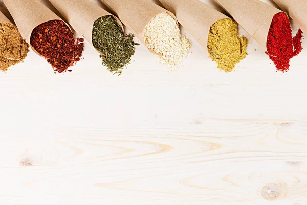 Varied powder spices close-up on  white wooden board with  copy space. — Stock Photo, Image