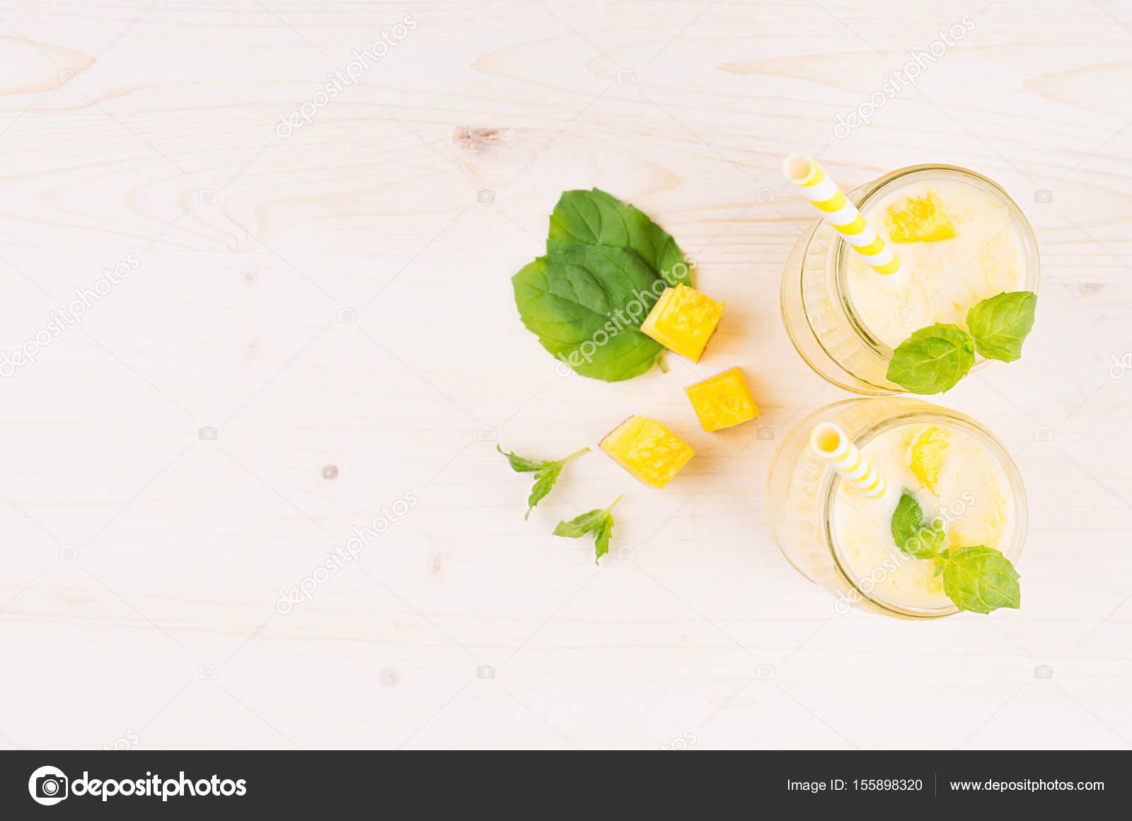 Decorative Border Of Yellow Mango Fruit Smoothie In Glass Jars