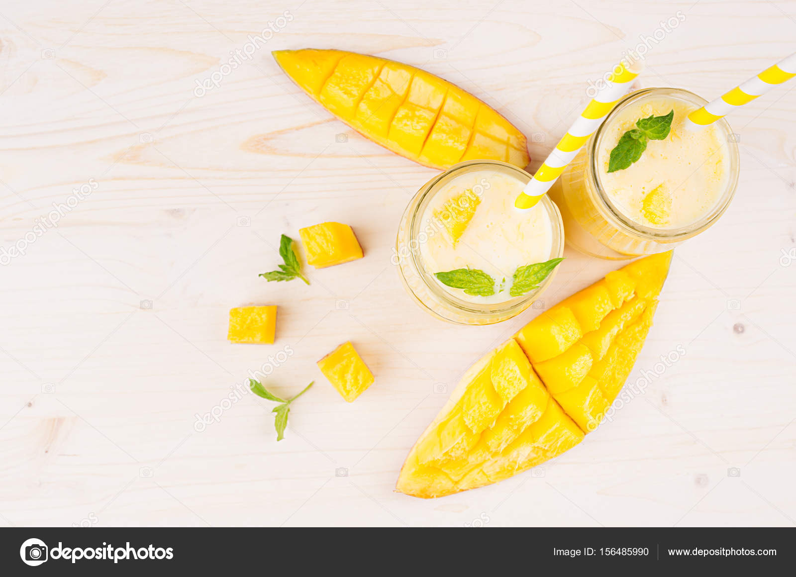 Decorative Border Of Yellow Mango Fruit Smoothie In Glass Jars