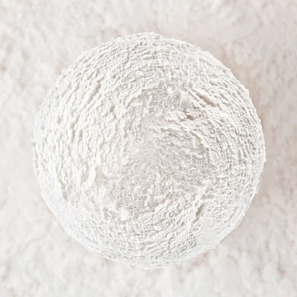White creamy ice cream ball on white textured background.