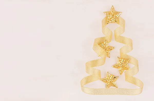 Christmas tree of gold stars, curl ribbons on soft white wood background. — Stock Photo, Image