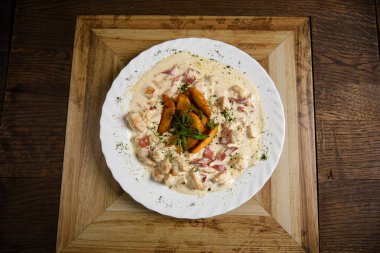 Sulu bir krema içinde doğranmış tavuk ve pastırma.