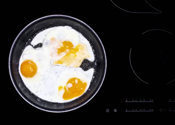 Tree fried eggs cooked in frying pan — Stock Photo, Image