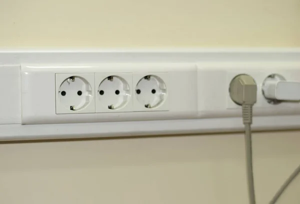 tree white Power sockets with frame on beige background wall as