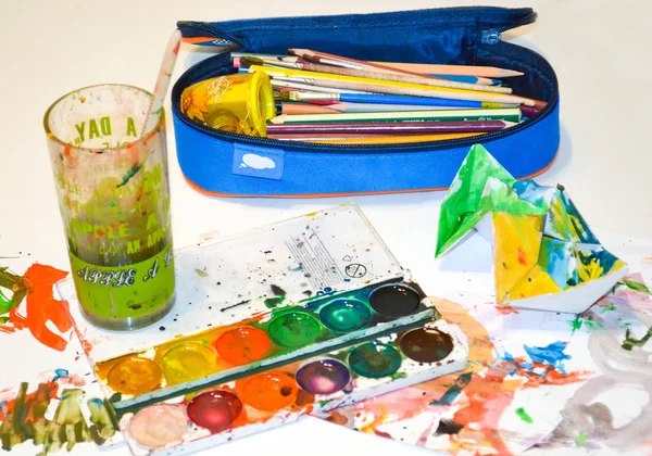 Pencil case with watercolor and glass — Stock Photo, Image