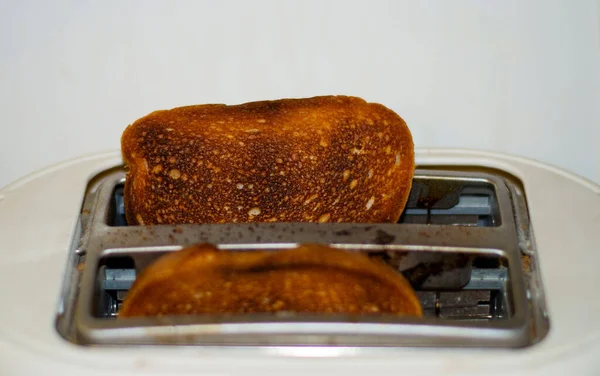 Bread toaster cooking bread by heating element — Stock Photo, Image