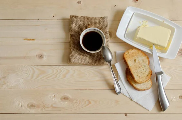 Sabah kahvesi ve tereyağlı tost makineleri. Canlandırıcı bir kahvaltı. arkaplan olarak ahşap tablo