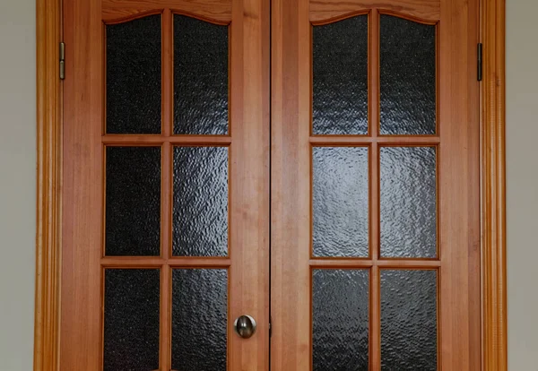 interior doors in the apartment. the door is locked, dark glass inserts in the doors.