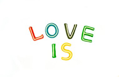 Aşk ve aşk, beyaz arkaplandaki farklı renklerdeki plastikin harflerden oluşur. Plastik modelleme anaokulu eğitimi, modelleme, farklı fikirler için tasarım.