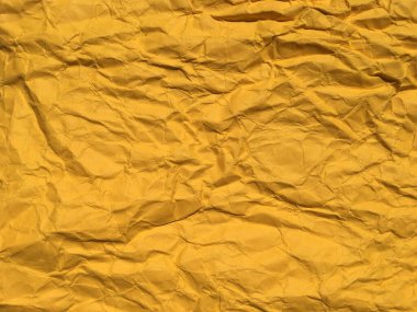 Tasarım için sarı buruşuk kağıdın soyut dokusu. Metin veya çalışma için boşluk kopyala 