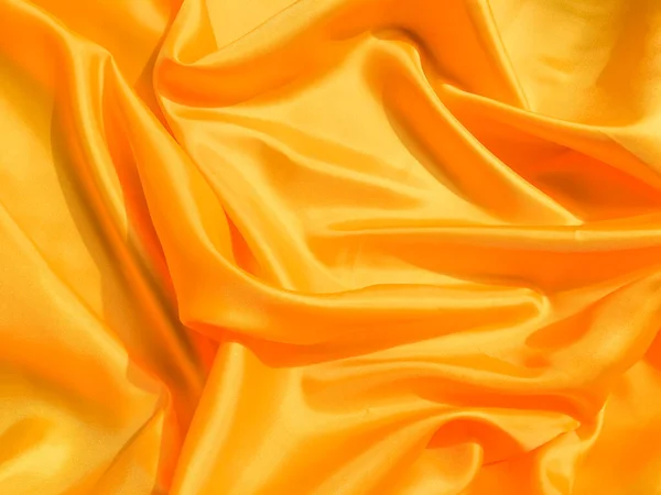 Yellow silk or satin texture background with copy space for design