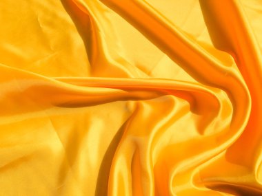 Tasarım ve sanat çalışmaları için kopyalama alanı olan güzel sarı ipek ya da saten desen arkaplanı 