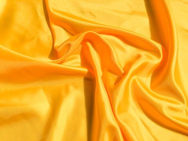 Tasarım ve sanat çalışmaları için kopyalama alanı olan güzel sarı ipek ya da saten desen arkaplanı 