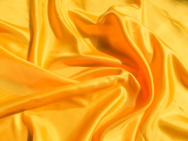 Tasarım ve sanat çalışmaları için kopyalama alanı olan güzel sarı ipek ya da saten desen arkaplanı 