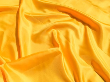 Tasarım ve sanat çalışmaları için kopyalama alanı olan güzel sarı ipek ya da saten desen arkaplanı 