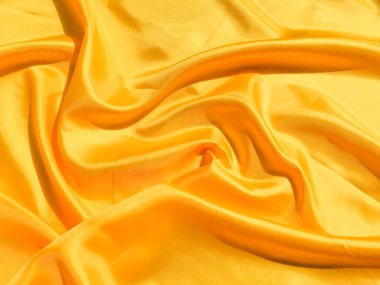 Tasarım ve sanat çalışmaları için kopyalama alanı olan güzel sarı ipek ya da saten desen arkaplanı 