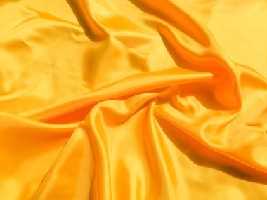 Tasarım ve sanat çalışmaları için kopyalama alanı olan güzel sarı ipek ya da saten desen arkaplanı 