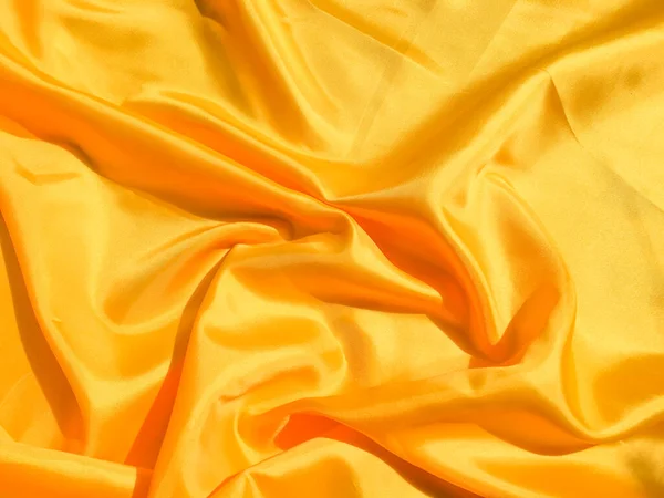 Beautiful yellow silk or satin texture background with copy space for design and artwork