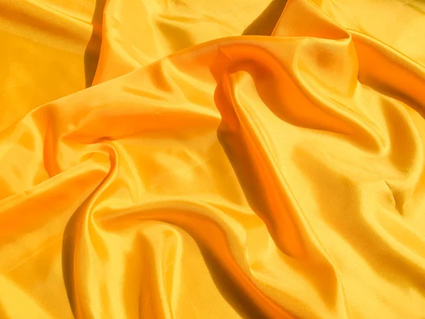 Beautiful yellow silk or satin texture background with copy space for design and artwork