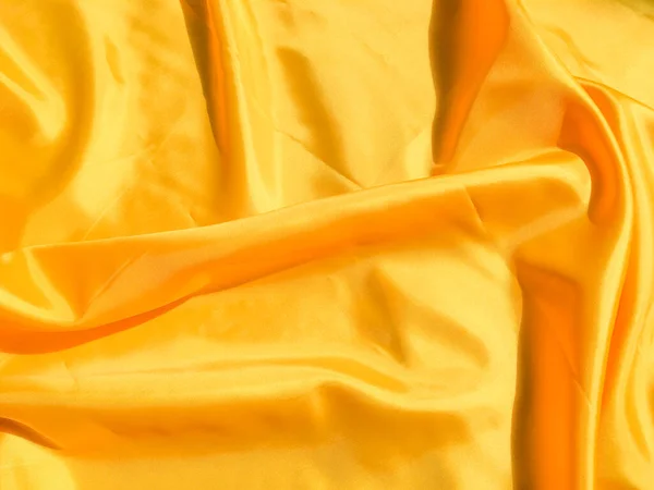 Beautiful yellow silk or satin texture background with copy space for design and artwork
