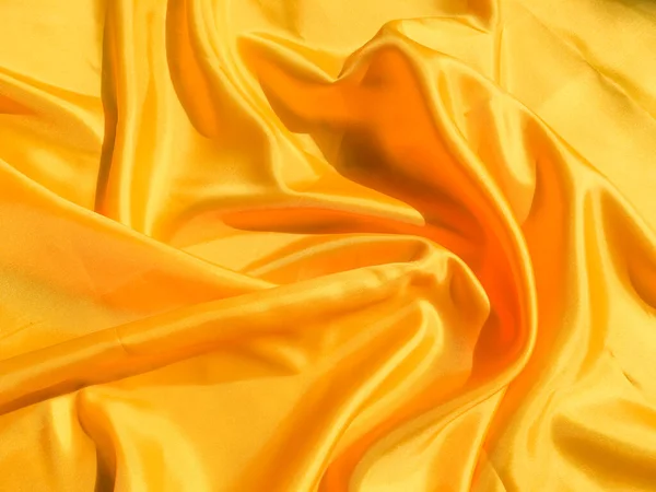 Beautiful yellow silk or satin texture background with copy space for design and artwork