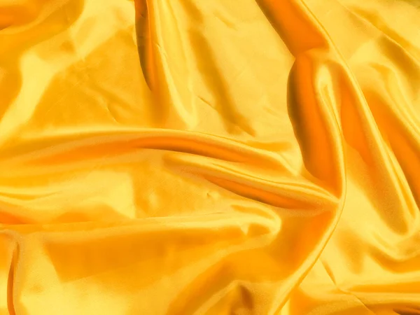 Beautiful yellow silk or satin texture background with copy space for design and artwork