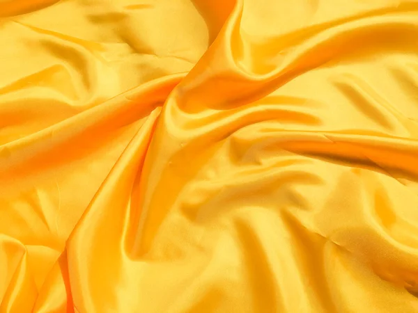 Beautiful yellow silk or satin texture background with copy space for design and artwork