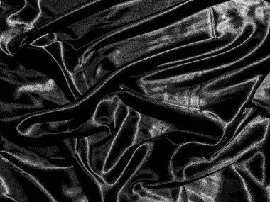 Siyah kumaş ya da kumaş arkaplanda sıvı dalga ya da dalgalı kıvrımlar. Duvar kağıdı tasarımı