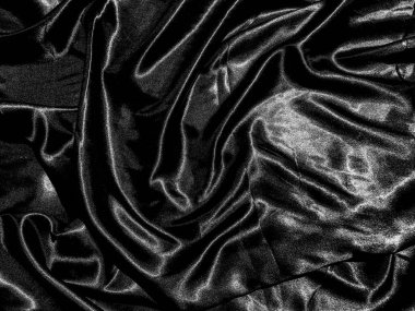 Siyah kumaş ya da kumaş arkaplanda sıvı dalga ya da dalgalı kıvrımlar. Duvar kağıdı tasarımı