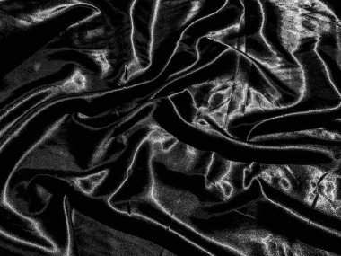 Lüks siyah ipek ya da sıvı dalgalı ya da dalgalı kıvrımlı saten arkaplan. Duvar kağıdı tasarımı