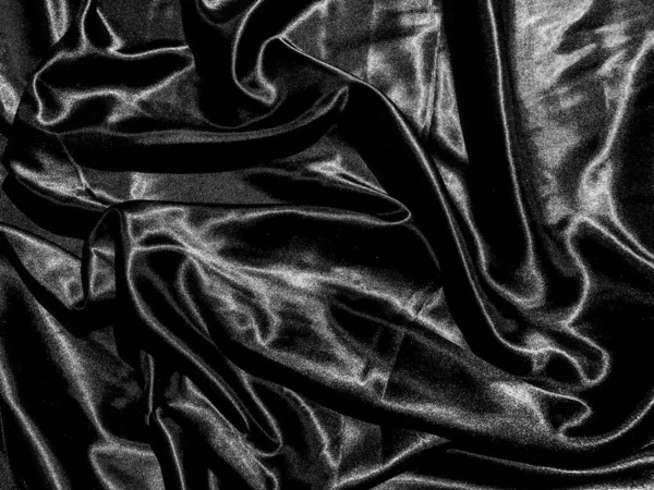 Black satin texture background with liquid wave or wavy folds. Wallpaper design