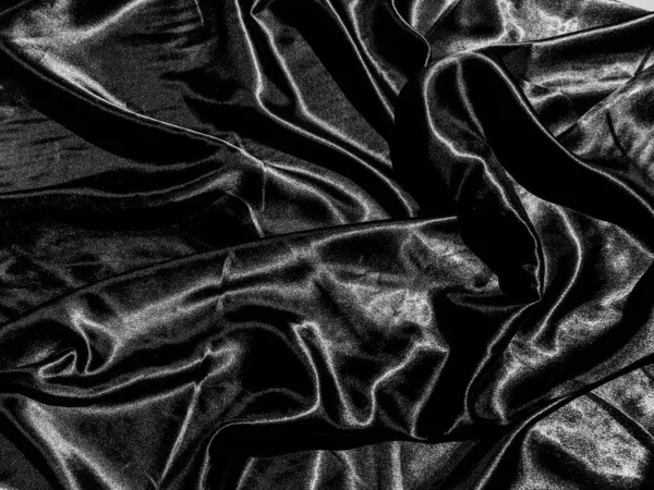 黒い布や布のテクスチャの背景に液体波や波状の折り目 壁紙デザイン — ストック写真