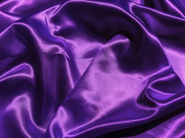 Mor kumaş arkaplanının deseni. Tasarım için dalgalı ipek kumaş kıvrımları saten kadife kumaş