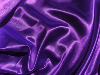 Mor kumaş arkaplanının deseni. Tasarım için dalgalı ipek kumaş kıvrımları saten kadife kumaş