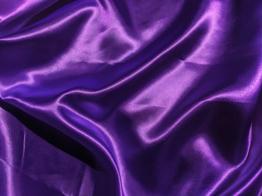 Mor kumaş arkaplanının deseni. Tasarım için dalgalı ipek kumaş kıvrımları saten kadife kumaş