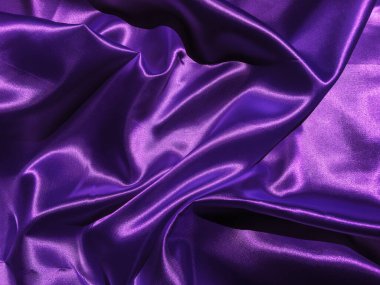 Tasarım için kopyalama alanı olan pürüzsüz mor kumaş veya saten doku arkaplanı