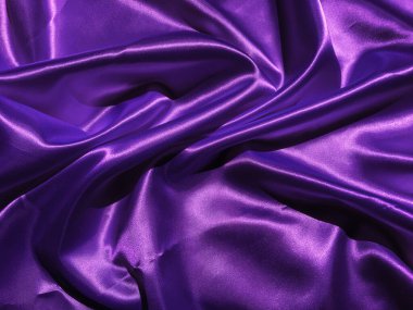 Tasarım için kopyalama alanı olan pürüzsüz mor kumaş veya saten doku arkaplanı