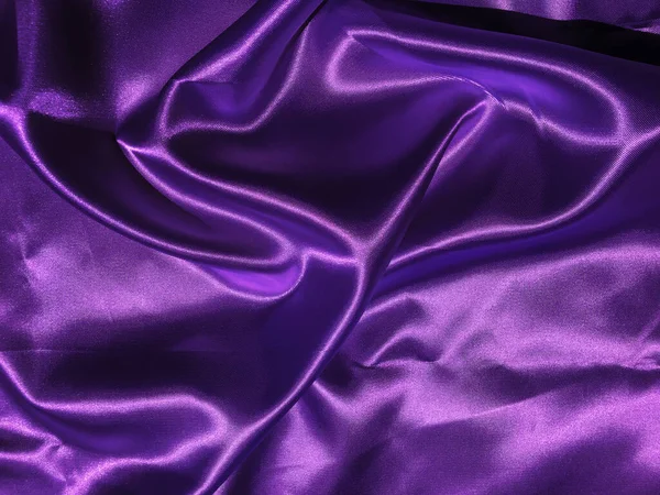 Smooth purple fabric or satin texture background with copy space for design