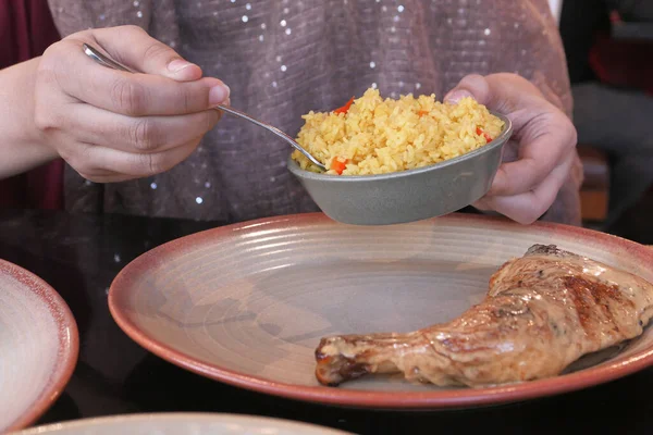 Close up of women hand serving rice — Stok fotoğraf