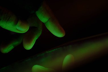 Close up of hacker hand steeling data