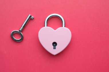 top view of Heart shape lock on pink background