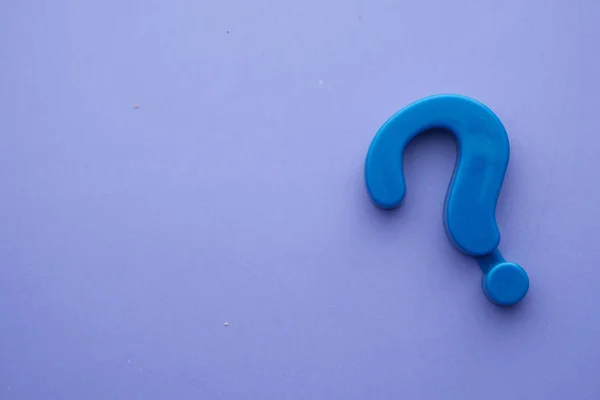 Close up of question mark on color background