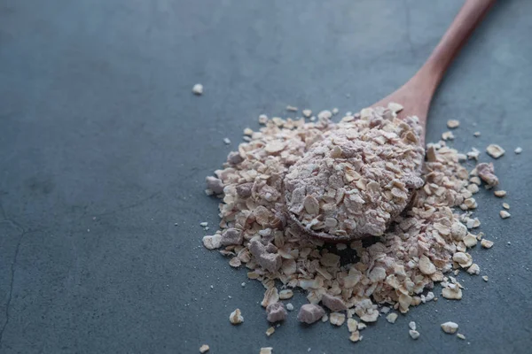 Close up of oat on spoon on color background — Stock Photo, Image